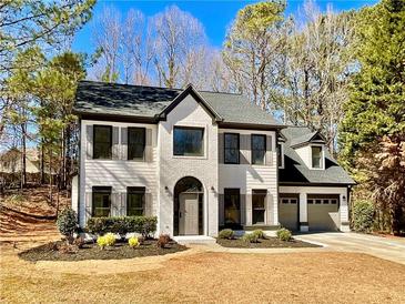 Charming two-story home with a brick and siding facade, complemented by well-maintained landscaping and a two-car garage at 3850 Westwick Nw Way, Kennesaw, GA 30152