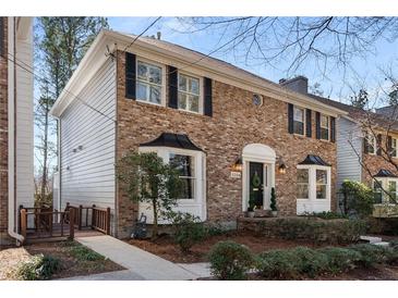 Charming brick townhome with black shutters and a well-manicured front yard, showcasing its inviting curb appeal at 2384 Defoors Ferry Nw Rd, Atlanta, GA 30318