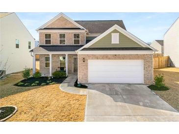 Charming two-story home featuring a brick facade and a two-car garage at 1333 Maston Rd, Auburn, GA 30011