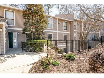 Inviting condo exterior featuring a fenced yard and neutral siding, perfect for low-maintenance living at 1307 Wynnes Ridge Se Cir, Marietta, GA 30067