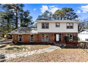 Charming two-story home with a brick facade and a welcoming front entrance at 67 Blue Springs Sw Ct, Lilburn, GA 30047