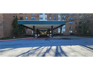 Exterior shot of covered building entrance and drive with adjacent landscaping features at 2965 Pharr Court South Nw # 316, Atlanta, GA 30305