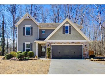 Charming two-story home with a stone-accented garage and well-manicured landscaping at 3480 Buffington Ln, Cumming, GA 30040