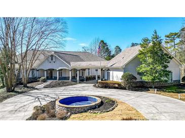 Stunning home with manicured landscaping, circular driveway, and inviting covered entryway at 2150 Fincher Rd, Canton, GA 30114