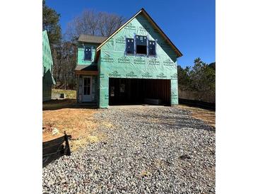 A home's exterior showing the two-car garage and construction materials at 3017 Abelia Dr, Buford, GA 30519