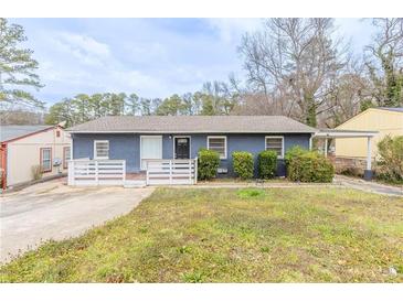 Charming one-story home with a manicured lawn, complemented by a welcoming entryway and a cozy front porch at 2631 Santa Barbara Nw Dr, Atlanta, GA 30318
