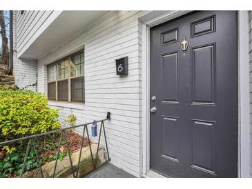 Charming front door with a knocker and brick wall on the exterior of the house at 1683 Briarcliff Rd # 6, Atlanta, GA 30306