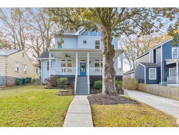 Charming two-story home with a covered front porch, walkway and mature landscaping at 1591 Alder Se Ct, Atlanta, GA 30317