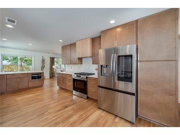 Modern kitchen features stainless steel appliances, wooden cabinetry, and hardwood floors at 2569 Woodhill Ln, Atlanta, GA 30344