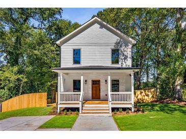 Charming two-story home featuring a welcoming front porch, fresh landscaping, and a classic white facade at 891 Thurmond Nw St, Atlanta, GA 30314