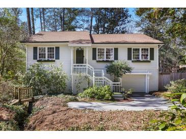 Charming home with a beautiful front yard, inviting entrance, and convenient attached garage at 2484 Oldfield Nw Rd, Atlanta, GA 30327