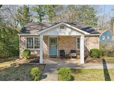 Charming brick home featuring a covered front porch and a well-maintained landscaped front yard at 3261 Lowndes St, Atlanta, GA 30337