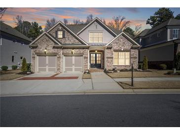 Charming brick home with a two-car garage and inviting front entrance at 10570 Grandview Sq, Johns Creek, GA 30097