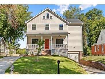 Charming two-story home with a welcoming front porch and well-manicured lawn at 1819 Avon Ave, Atlanta, GA 30311