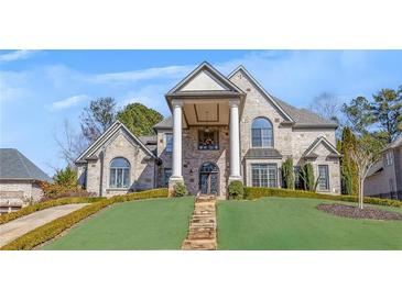 Stately brick home with a covered front porch, featuring elegant columns and landscaped grounds at 426 Lanesborough Dr, Marietta, GA 30064
