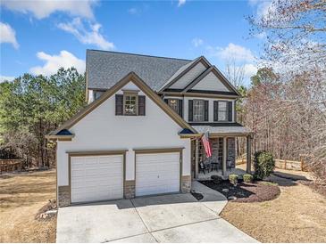 Charming two-story home with a well-manicured lawn and a two-car garage at 237 Elmbrook Ln, Canton, GA 30114