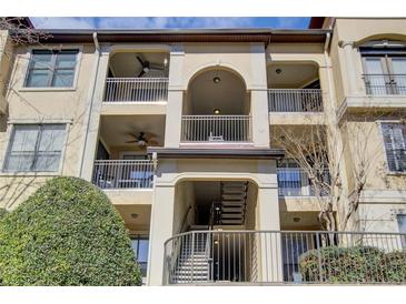 Multi-level condo building featuring balconies with decorative railings and neutral-toned facade at 3777 Peachtree Ne Rd # 722, Brookhaven, GA 30319