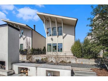 Modern home showcasing a unique architectural style with clean lines and complemented by a beautifully landscaped yard at 165 Breakspear Ln, Fayetteville, GA 30214