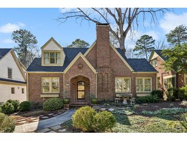 Charming brick home with a well-manicured front yard and beautiful landscaping at 1696 N Pelham Ne Rd, Atlanta, GA 30324