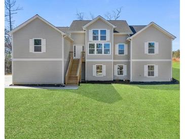 Charming two-story home featuring double-hung windows and a well-manicured lawn at 939 Whistler Ln, Canton, GA 30114