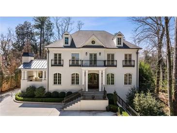 Stunning white brick home featuring multiple balconies and a manicured front yard at 18 Blackland Nw Rd, Atlanta, GA 30342