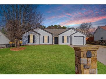 Charming single-story home with a well-manicured lawn, inviting curb appeal, and neutral exterior paint at 6800 Bells Landing Way, Rex, GA 30273