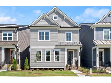 Charming two-story home with gray siding, white trim, and a well-maintained lawn at 1929 Quarry Park Nw Pl, Atlanta, GA 30318
