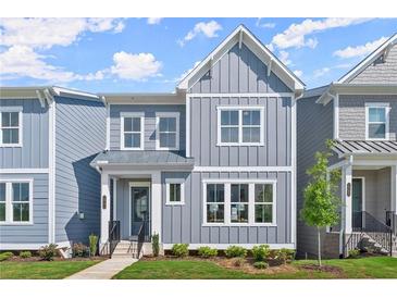 Charming two-story townhome with gray siding, white trim, and a well-manicured front yard at 1941 Quarry Park Nw Pl, Atlanta, GA 30318
