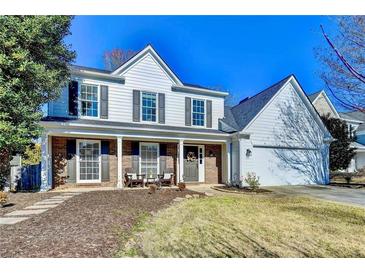 Charming two-story home with a welcoming front porch and well-maintained landscaping at 2389 Lake Villas Ln, Duluth, GA 30097