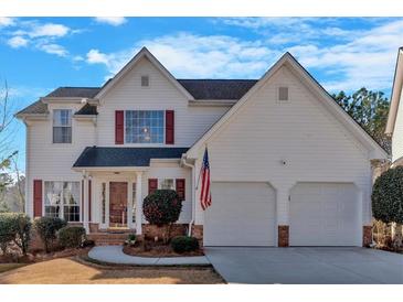 Charming two-story home with white siding, red shutters, and an attached two-car garage at 2452 Lakebrooke Dr, Marietta, GA 30066