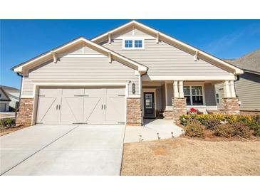 Charming home with a two-car garage, stone accents, and a welcoming front porch at 351 Clay St, Grayson, GA 30017