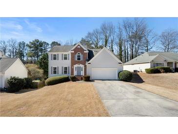 Well-maintained home with charming curb appeal, manicured shrubs, and a two-car garage at 2740 Woodbine Hill Way, Norcross, GA 30071
