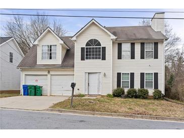 Charming two-story home with attached garage and traditional architectural details at 3958 Waldrop Hills Dr, Decatur, GA 30034