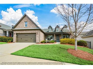 Charming brick home with a well-manicured lawn, attached two-car garage and covered front porch at 624 Hemlock Trl, Canton, GA 30114