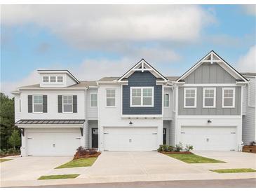 Modern townhome exteriors featuring attached garages, charming designs and well-maintained landscaping at 1616 Aiden Way # 65, Conyers, GA 30013