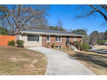 Charming brick home featuring a long driveway and well-maintained front yard at 3140 Westmart Ln, Atlanta, GA 30340