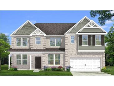 Charming two-story home featuring a brick facade, a two-car garage, and a well-maintained front yard at 308 Moab Ct, Stockbridge, GA 30281