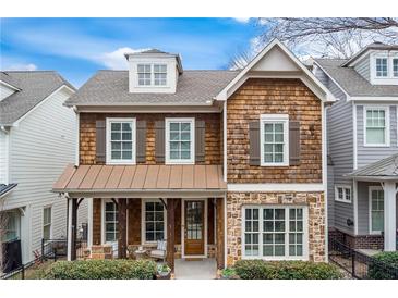 Charming craftsman-style home with cedar shake siding, stone accents, and inviting front porch at 1918 Coal Pl, Atlanta, GA 30318