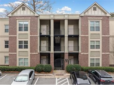 Charming brick condo building with courtyard access and well-maintained landscaping at 1903 Anjaco Nw Rd # 3, Atlanta, GA 30309