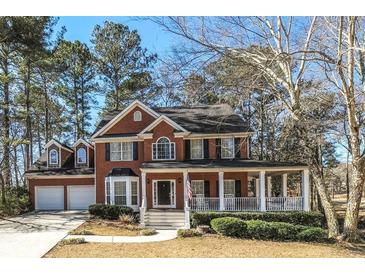 Charming two-story brick home with a welcoming front porch and well-maintained landscaping at 9937 Between The Grns, Villa Rica, GA 30180