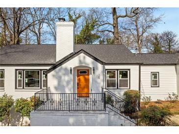 Charming single-Gathering home with a brick exterior, a well-manicured lawn, and a bright orange front door at 10 Claire Se Dr, Atlanta, GA 30315