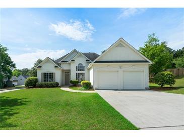 Charming two-story home with an attached two-car garage and a well-manicured lawn at 3047 Standing Rock Ct, Lithia Springs, GA 30122