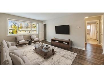 Bright living room with large window, hardwood floors, and modern furnishings perfect for relaxation and entertaining at 449 Clairemont Ave # E1, Decatur, GA 30030