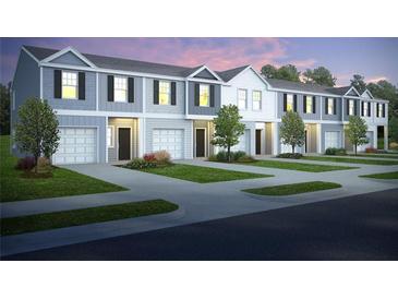 New townhomes showcase craftsman-style architecture, attached garages, and professionally landscaped lawns at 9444 Cedar Grove Ct # 335, Jonesboro, GA 30238