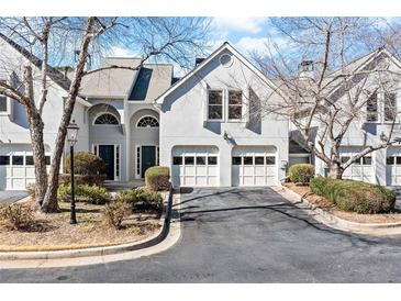 Charming townhome with a two-car garage, neat landscaping, and inviting curb appeal at 3928 Ashford Lake Ne Ct, Brookhaven, GA 30319