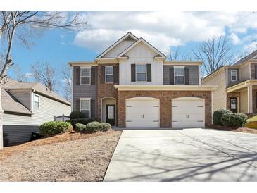 Charming two-story home featuring a two car garage and beautiful stone and siding facade at 5232 Centennial Hill Nw Dr, Acworth, GA 30102