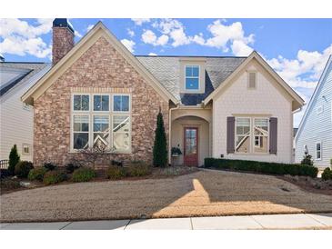 Charming home showcasing a stone facade, well-manicured lawn, and inviting entrance at 336 Little Pine Ln, Woodstock, GA 30188