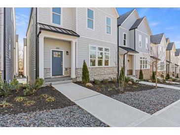 Charming townhome featuring a welcoming entrance, stone accents, and meticulous landscaping at 489 Hammons Way, Atlanta, GA 30315