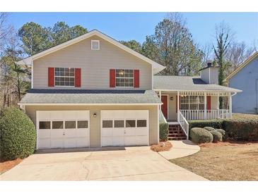 Charming two-story home with a welcoming front porch and a two-car garage at 5537 Riverside Dr, Sugar Hill, GA 30518