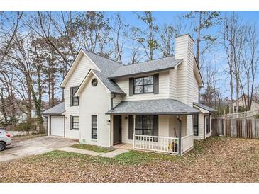 Charming two-story home with white siding, brick accents, and inviting front porch at 9556 River Ct, Jonesboro, GA 30238